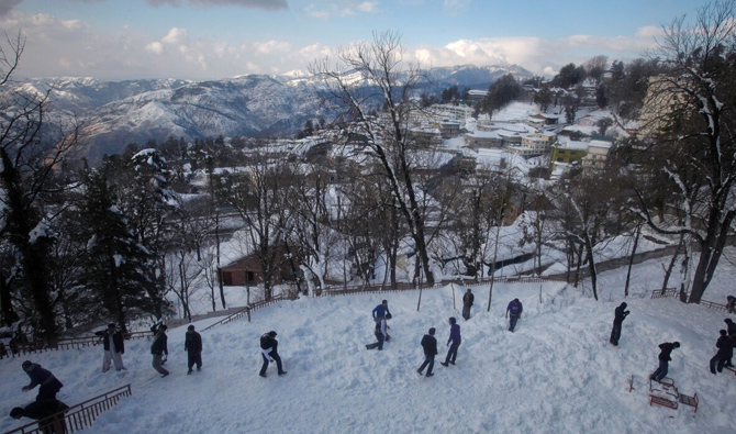 Tourists enjoy the snow at the hill resort town of Murree, 60 km (38 miles) northeast of the capital Islamabad, February 5, 2012. (Reuters/File)