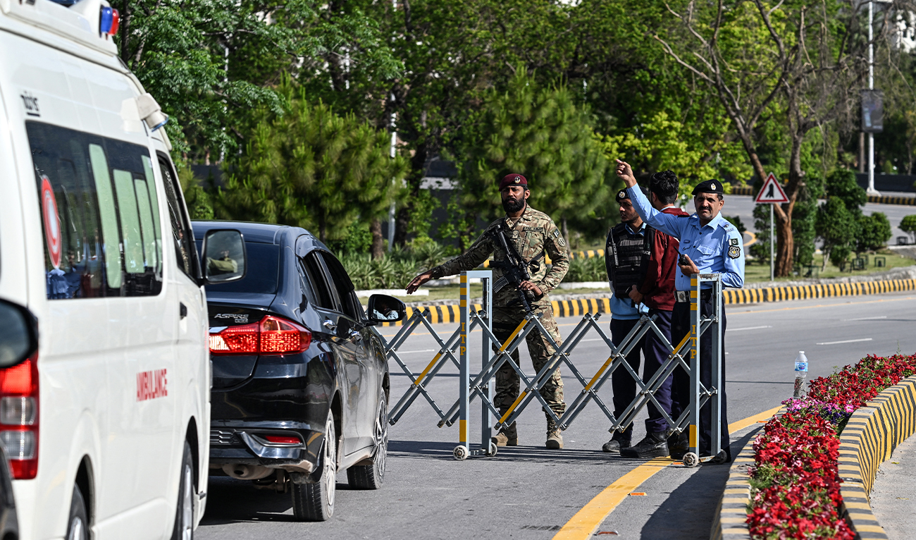 Security personnel divert traffic after closing the Red Zone area in Islamabad, Pakistan, on April 9, 2026. (AFP)