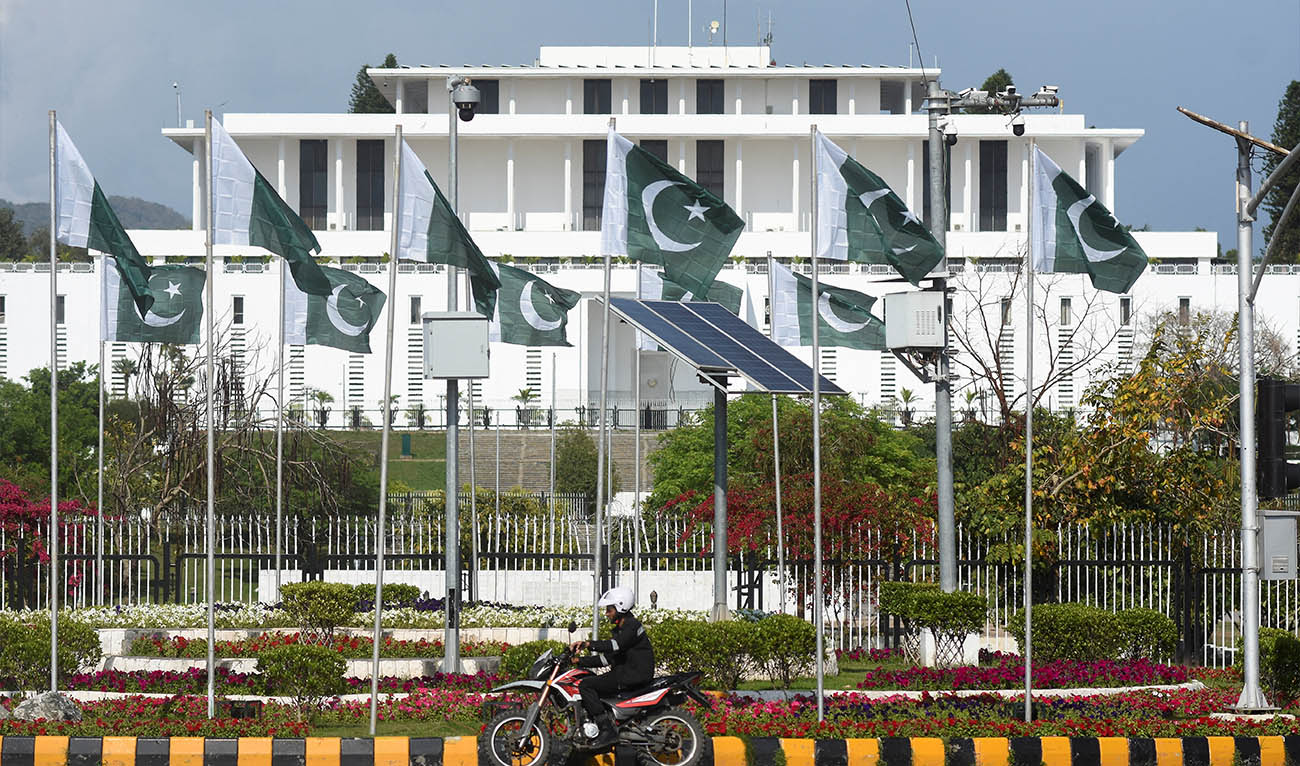 A man rides a motorcycle past the President house as Pakistan gears up to host the U.S. and Iran for peace talks, in Islamabad, Pakistan, April 9, 2026. (REUTERS)