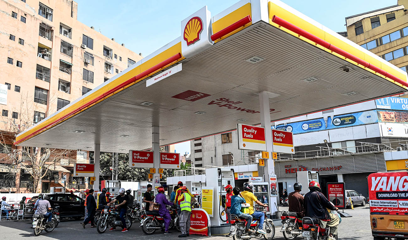 People wait to refuel their vehicles at a filling station in Lahore on March 9, 2026. (AFP/ file)