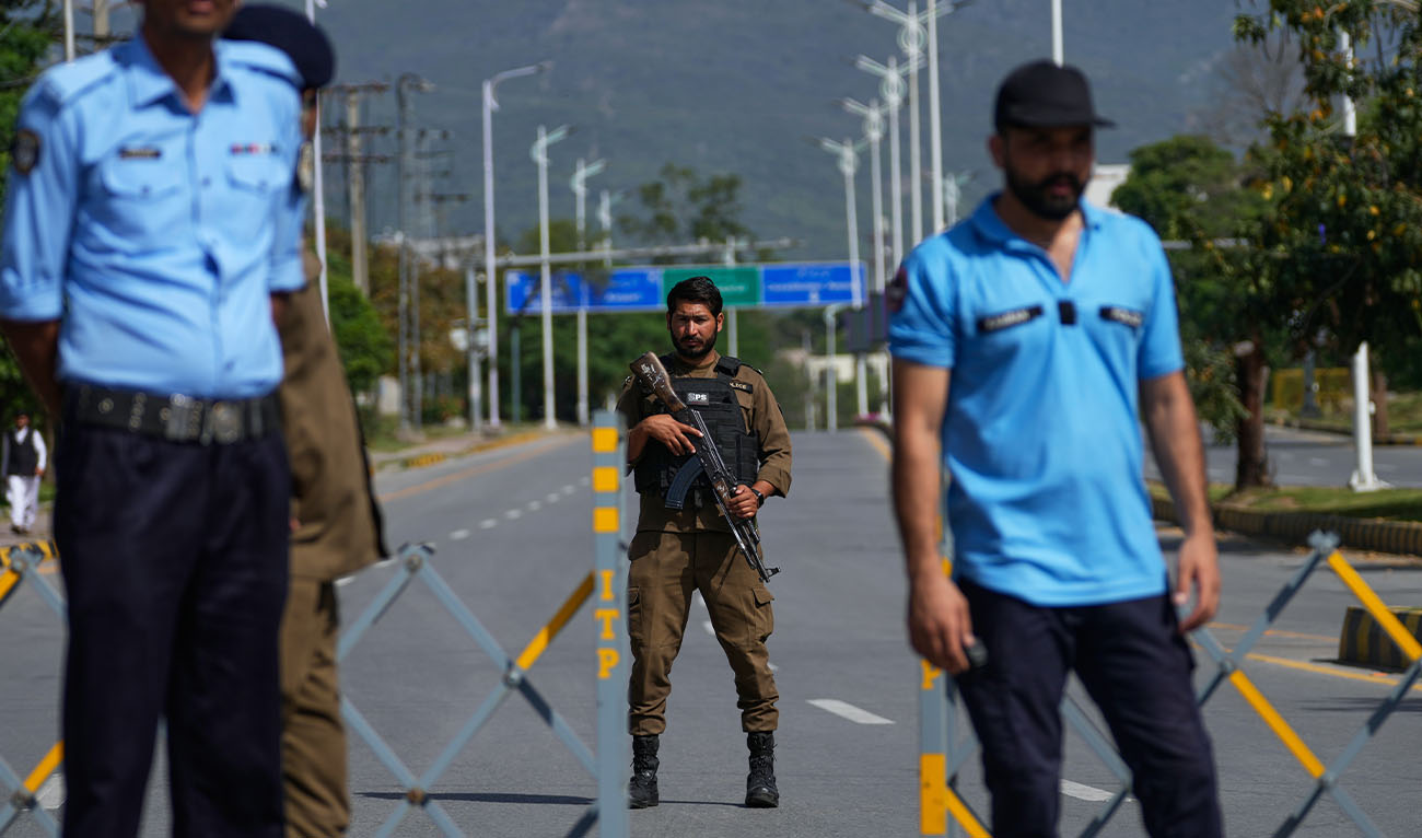Police officers stand guard at a checkpoint on a barricaded to ensure security ahead of the second round of negotiations between the U.S. and Iran, in Islamabad, Pakistan, Tuesday, April 21, 2026. (AP)