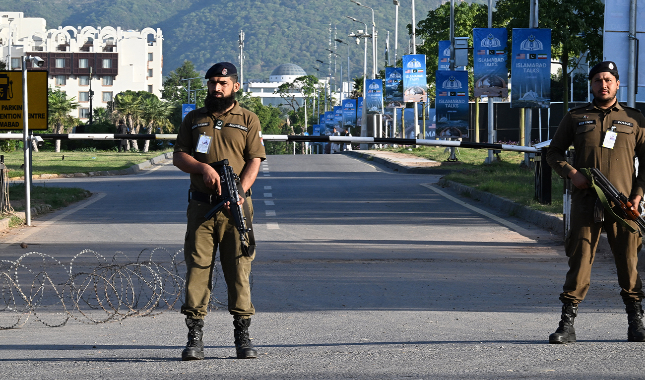 Police officers stand guard at a closed road leading to the Serena Hotel at the Red Zone area in Islamabad, Pakistan, on April 22, 2026. (AFP)