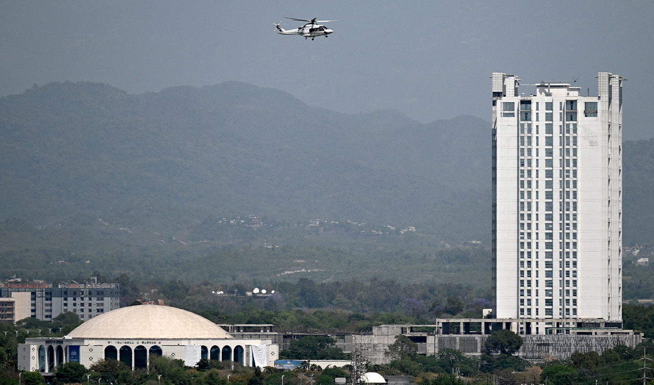 A helicopter flies over the Red Zone area in Islamabad on April 20, 2026, amid heightened security measures ahead of anticipated US-Iran peace talks. (AFP/File)