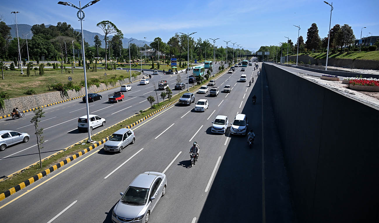 Commuters ride along a street near the Serena Hotel, that hosted the first round of US-Iran peace talks during the Middle East war, after authorities reopened the Red Zone area in Islamabad on April 26, 2026, following eased security measures and restrictions. (AFP/ file)