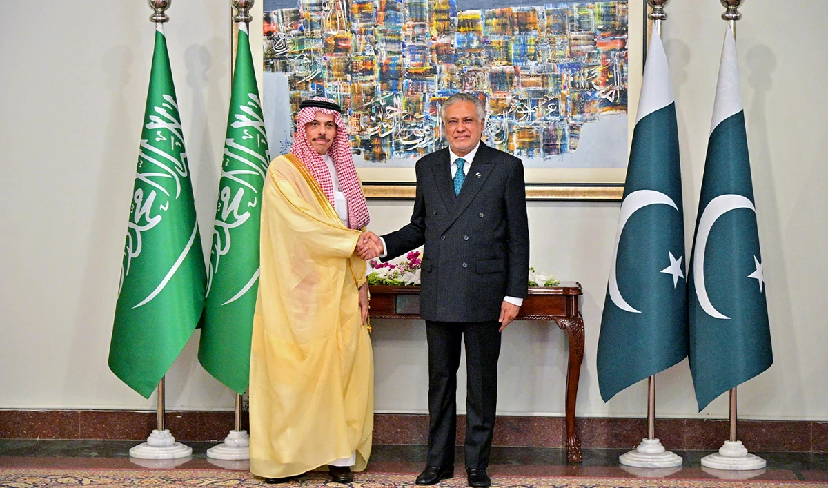This handout photograph taken on March 29, 2026, shows Pakistan’s Foreign Minister Ishaq Dar shaking hands with his Saudi Arabian counterpart Faisal bin Farhan (left), upon his arrival at the Foreign Ministry in Islamabad. (MOFA/AFP/File)