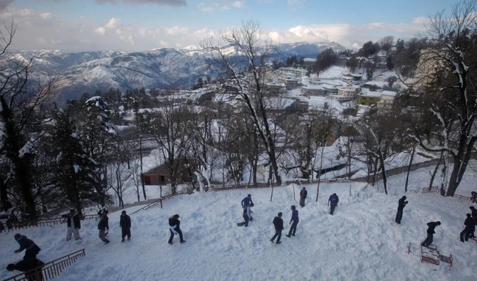 Tourists enjoy the snow at the hill resort town of Murree, 60 km (38 miles) northeast of the capital Islamabad, February 5, 2012. (Reuters/File)