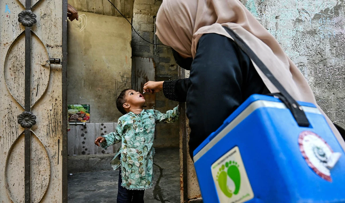 A health worker administers polio drops to a child for vaccination on the first day of a nationwide week-long poliovirus eradication campaign in Karachi on October 13, 2025. (AFP/ file)