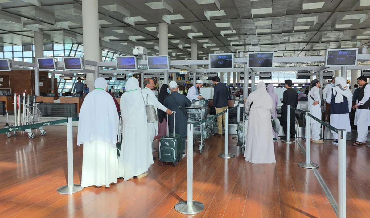 Hajj pilgrims at a check-in counter at Islamabad Airport on April 19, 2026. (Pakistan Ministry of Religious Affairs)