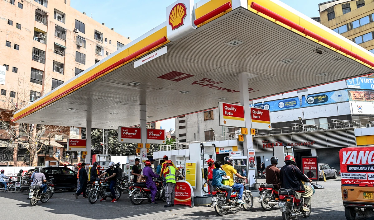 People wait to refuel their vehicles at a filling station in Lahore, Pakistan, on March 9, 2026. (AFP/File)