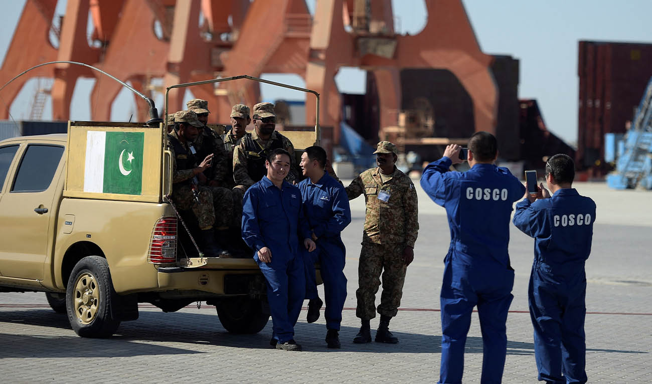 Chinese workers pose for a picture with Pakistani soldiers at a ceremony to open a pilot trade project in Gwadar port, some 700 kms west of Karachi on November 13, 2016. (AFP/ file)