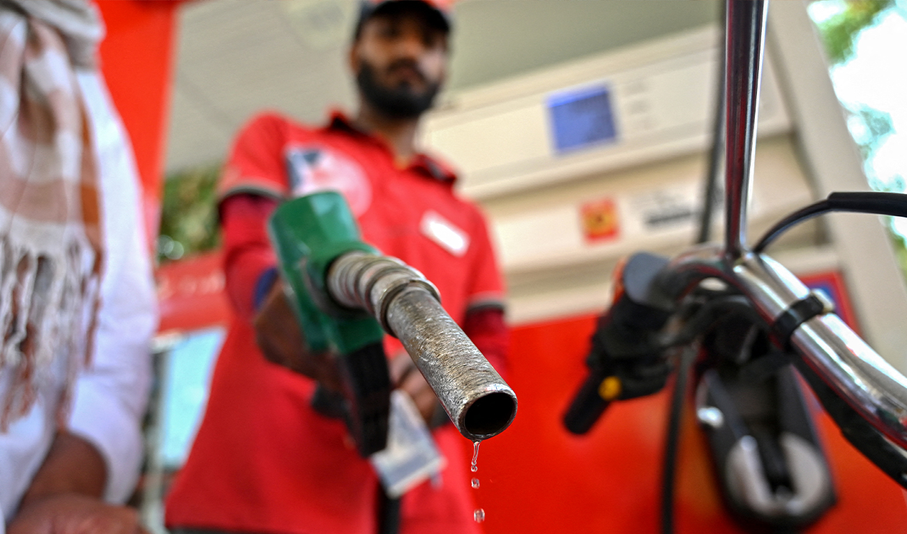 An employee fills the tank of a motorcycle at a fuel station in Islamabad, Pakistan, on April 25, 2026. (AFP/File)