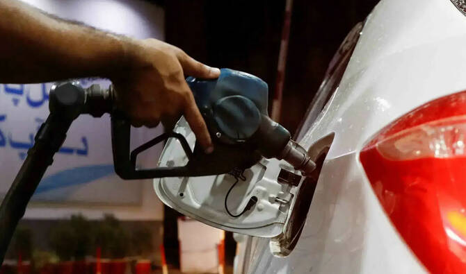 A worker holds a fuel nozzle to fills fuel in a car, after the government announced the increase of petrol and diesel prices, at petrol station in Karachi, Pakistan September 16, 2023. (Reuters/File)