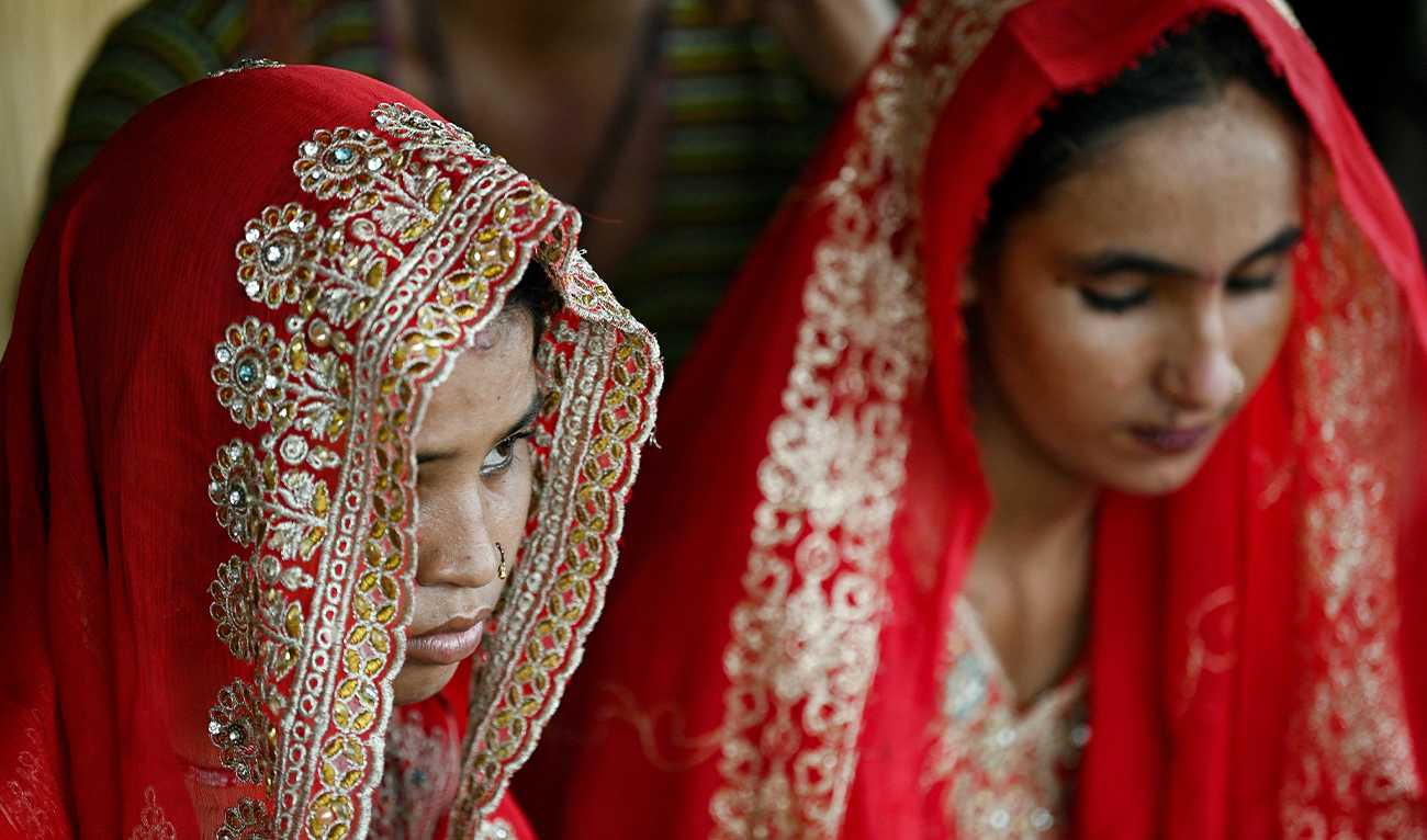 In this photograph taken on August 3, 2024, Shamila and Salma Zameer (right), monsoon brides who were married underage, look on at Khan Muhammad Mallah village of Dadu district in Sindh province, Pakistan. (AFP/File)
