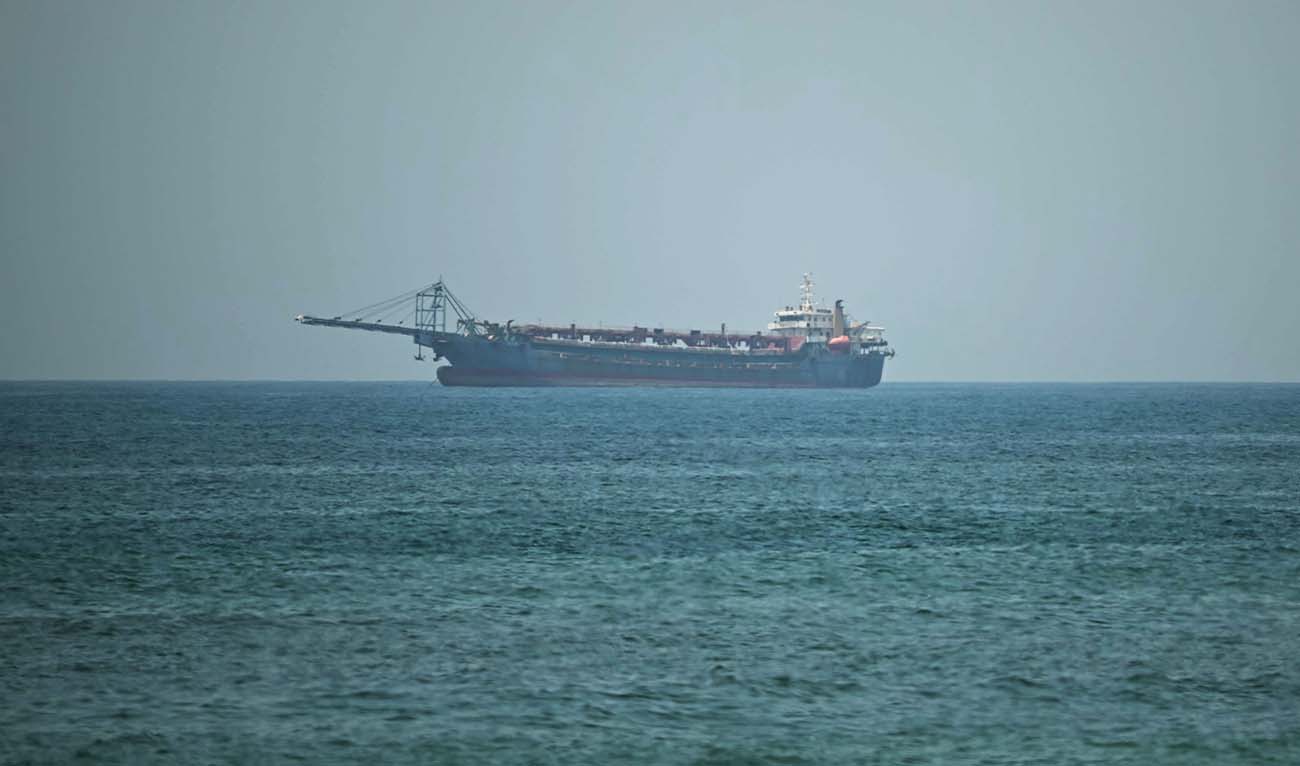 A vessel is seen in the Gulf, off the coast of the Sharjah on May 9, 2026. (AFP)