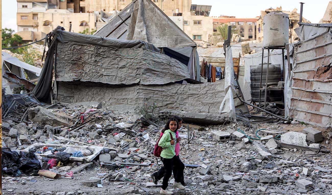 Children walk outside a residential building that was hit by an Israeli strike the previous day in the Rimal neighbourhood of Gaza City on May 16, 2026. (AFP/ file)