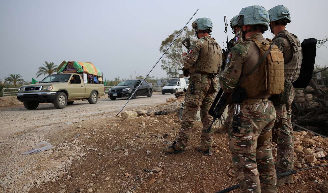 UN peacekeepers stand guard, as displaced people make their way back to their homes after crossing the bridge linking southern Lebanon to the rest of the country, following the ceasefire between Lebanon and Israel in Qasmiyeh, Lebanon, on April 18, 2026. (REUTERS/File)