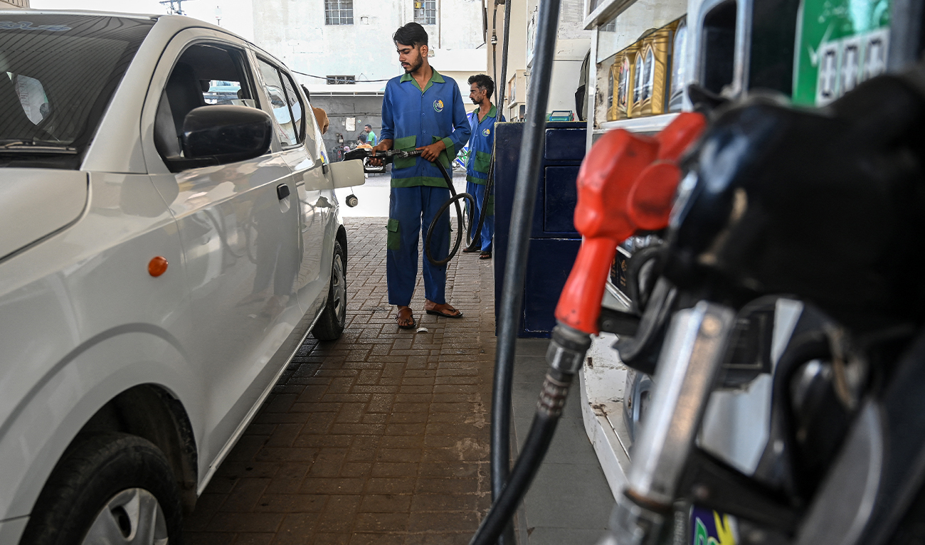 An employee fills the tank of a car at a fuel station in Karachi, Pakistan, on April 25, 2026. (AFP/File)