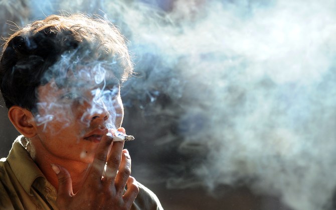 A Pakistani man smokes a cigarette in Lahore on May 31, 2011, on "World No Tobacco Day". (AFP/ file)