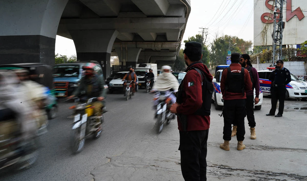 In this picture taken on February 1, 2023, Policemen stand guard along a street in Peshawar day after a mosque suicide blast inside a police headquarters. (AFP/ file)