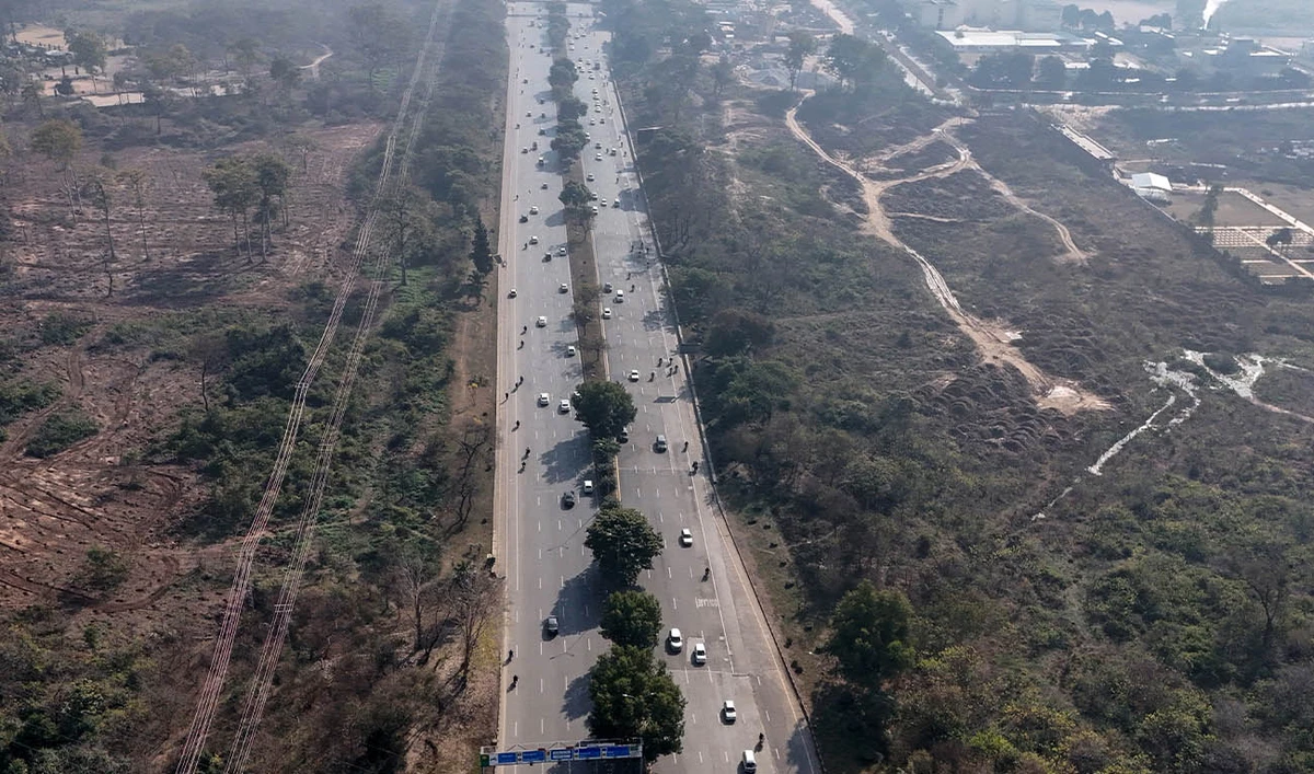 This photograph taken on January 7, 2026 shows an aerial view of commuters driving past a cleared patch (L) of the Shakarparian forest in Islamabad. (AFP/ file)