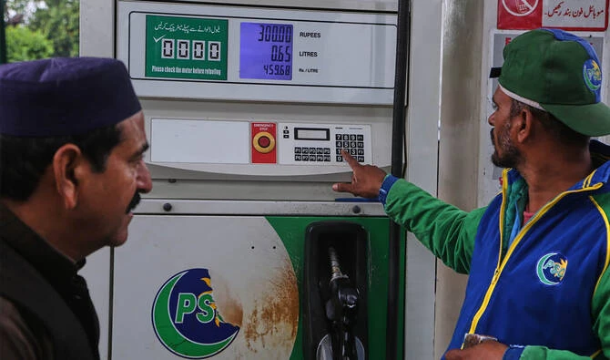 A motorcyclist looks at the display at a fuel station as he buys fuel after the government increased fuel prices amid surging global oil prices due to the Iran war, in Peshawar, Pakistan, Friday, April 3, 2026. (AP)