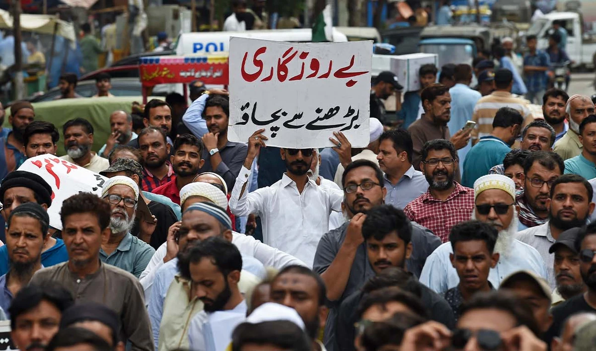 A trader holds a placard reading 'prevent unemployment from rising' during a protest at a street in Karachi on August 23, 2023. (AFP/ file)