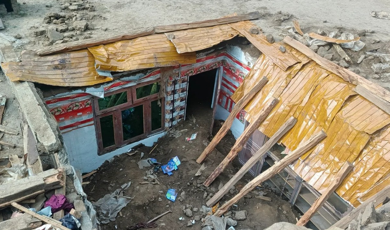 The photograph taken on June 2, 2026, shows the collapsed roof of a house in the town of Kooza Alpuri in Shangla district, Khyber Pakhtunkhwa province, Pakistan. (Umar Bacha)