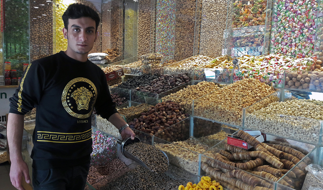 Sheraz Khan, a dry fruit trader in one of the upscale markets, shows pine nuts to a customer at his shop in Islamabad, Pakistan, on November 17, 2019. (AN/File)