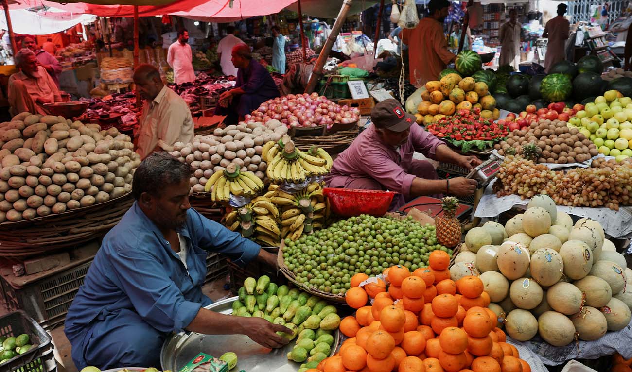 Vendors sell vegetables from makeshift stalls along a market, after oil price hike, amid the U.S.-Israeli conflict with Iran, in Karachi, Pakistan, March 13, 2026. (Reuters)