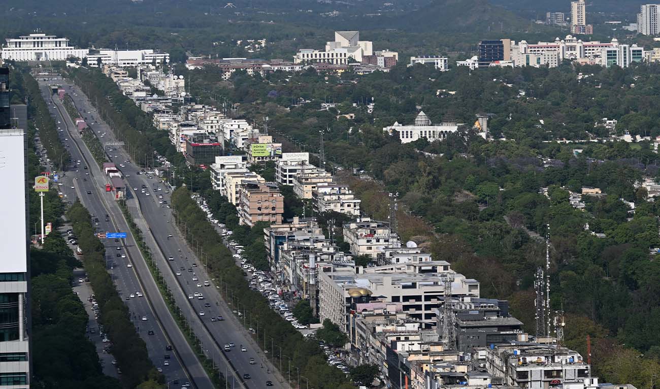 Commuters travel along a road leading to Pakistan's President House (C, left) in Islamabad on April 17, 2026. (AFP/ file)