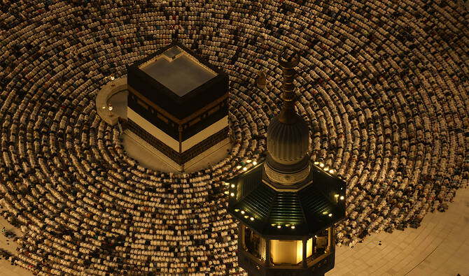 This aerial view shows the Grand Mosque complex as Muslims perform the evening prayer around the Kaaba, Islam's holiest shrine, on June 6, 2025. (AFP)