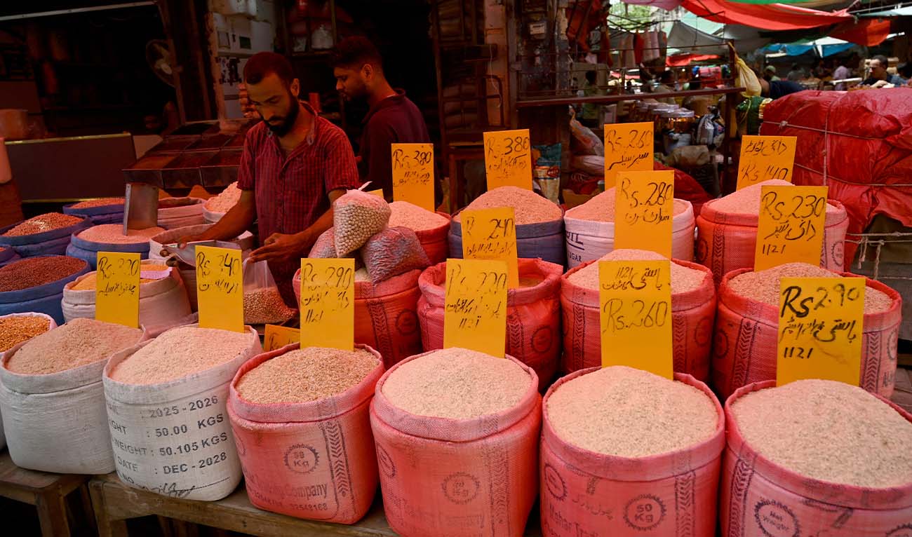 A shopkeeper selling rice waits for customers at a market in Karachi on June 12, 2026. (AFP/ File)