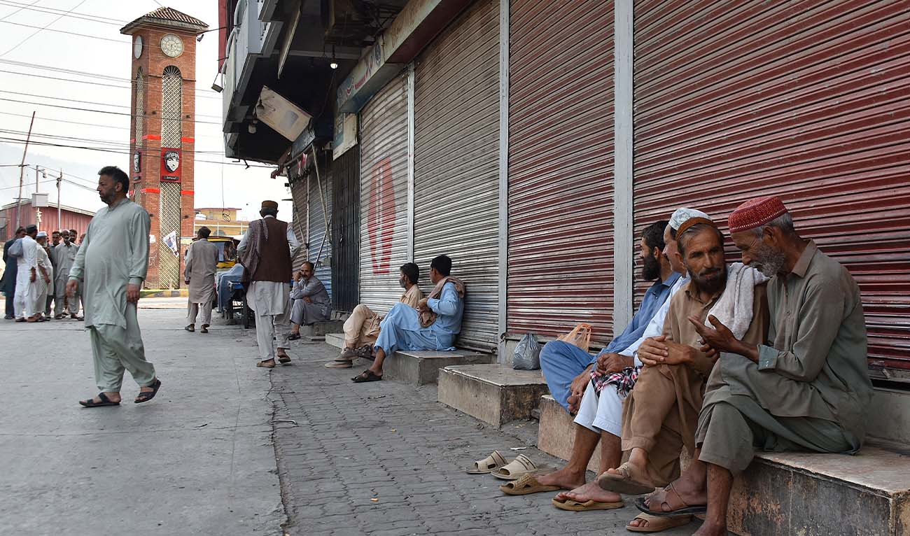 People gather near closed shops at a marketplace in Muzaffarabad, the capital of Pakistan-administered Kashmir on June 16, 2026 amid protests called by the Joint Awami Action Committee (JAAC) following the group’s ban under anti-terrorism laws by local authorities. (AFP)