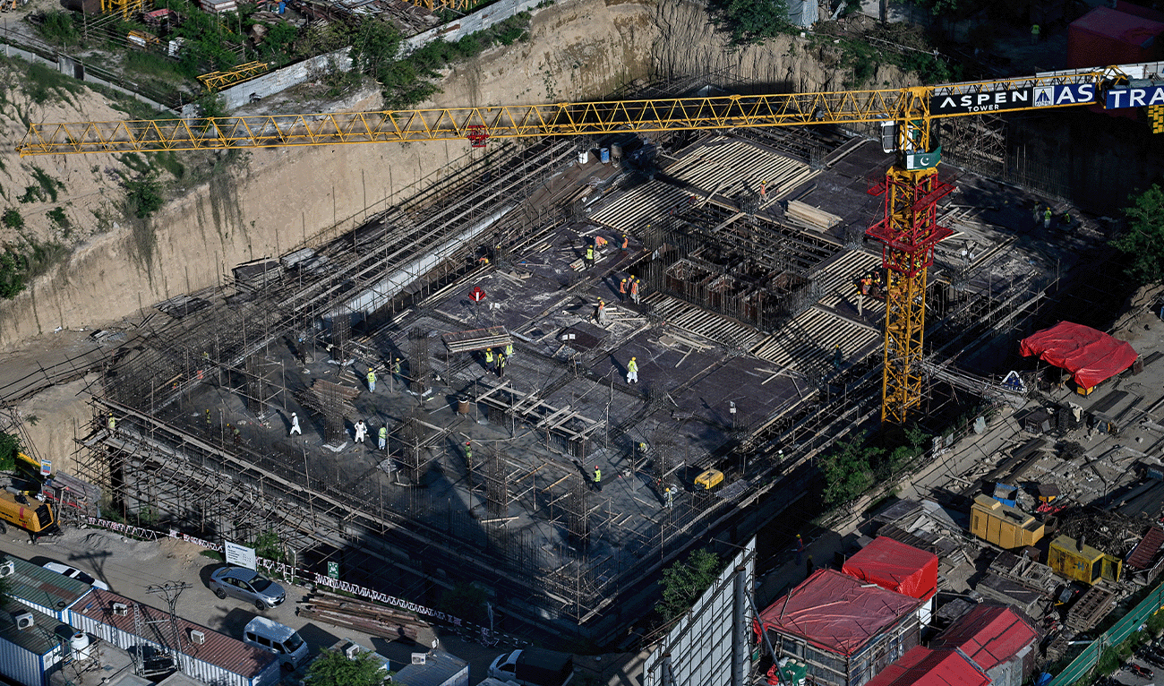 Construction labourers work on a multi-storey building project in Islamabad on April 22, 2026. (AFP/File)