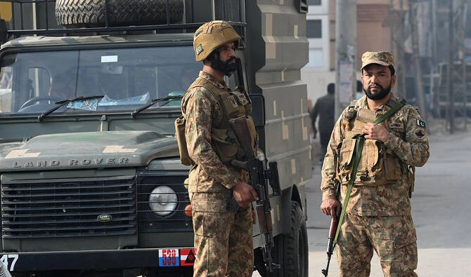 Security personnel stand guard at the site of a suicide attack outside the border force headquarters in Peshawar, Pakistan, on November 24, 2025. (AFP/File)