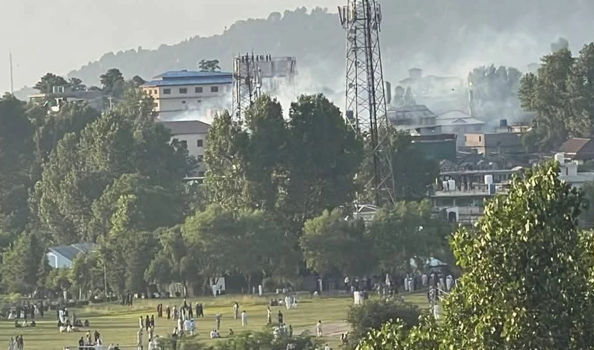 Smoke rises as people gather in Rawalakot, Azad Jammu and Kashmir, on June 7, 2026. (JAAC)