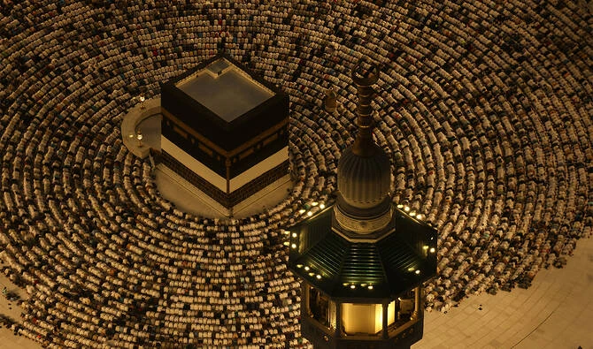 This aerial view shows the Grand Mosque complex as Muslims perform the evening prayer around the Kaaba, Islam's holiest shrine, on June 6, 2025. (AFP)