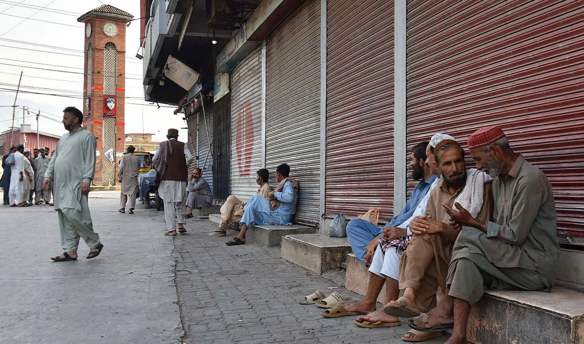 People gather near closed shops at a marketplace in Muzaffarabad, the capital of Pakistan-administered Kashmir on June 16, 2026 amid protests called by the Joint Awami Action Committee (JAAC) following the group’s ban under anti-terrorism laws by local authorities. (AFP)