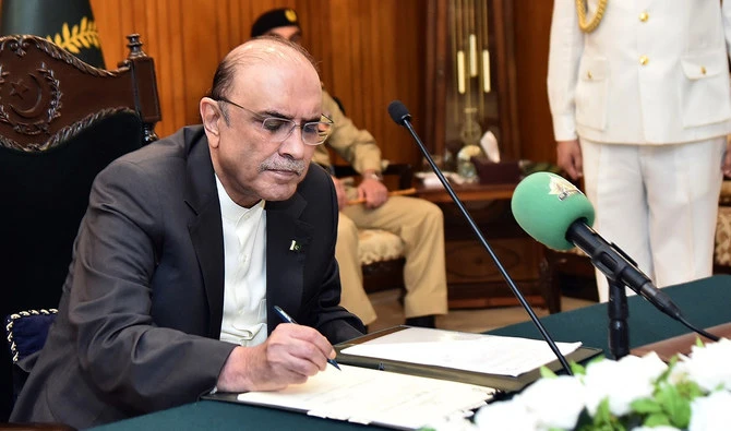This file photograph, taken and released by Pakistan's Press Information Department on July 23, 2024, shows Pakistan President Asif Ali Zardari signing an amendment bill at the President House in Islamabad. (PID/File)