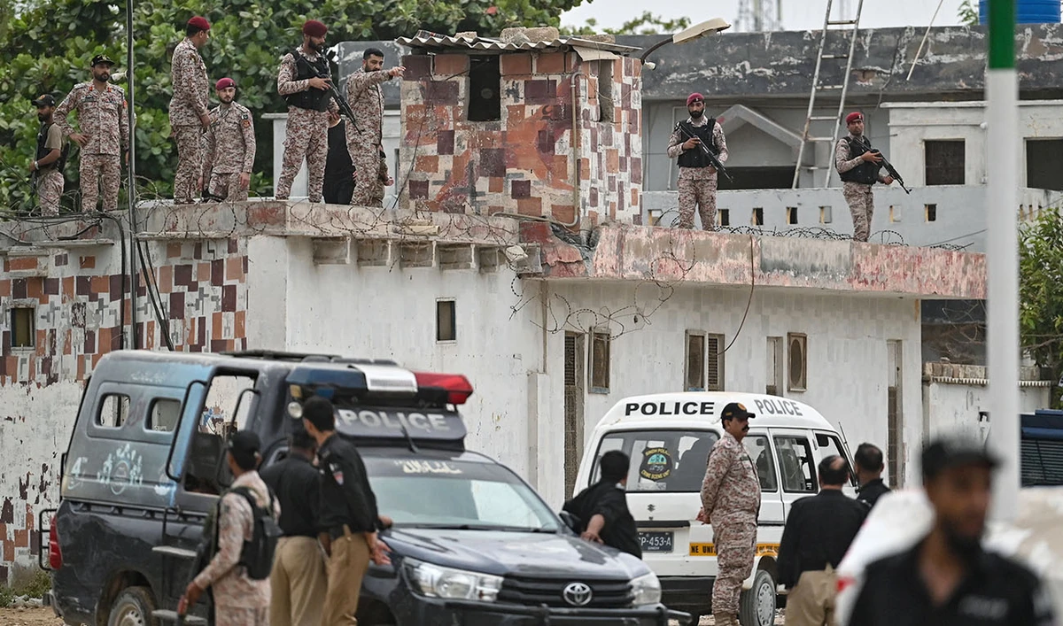 Security personnel inspect the rooftop of a compound at the end of a clearance operation following an alleged explosion and a militant attack in Karachi on June 28, 2026. (AFP)
