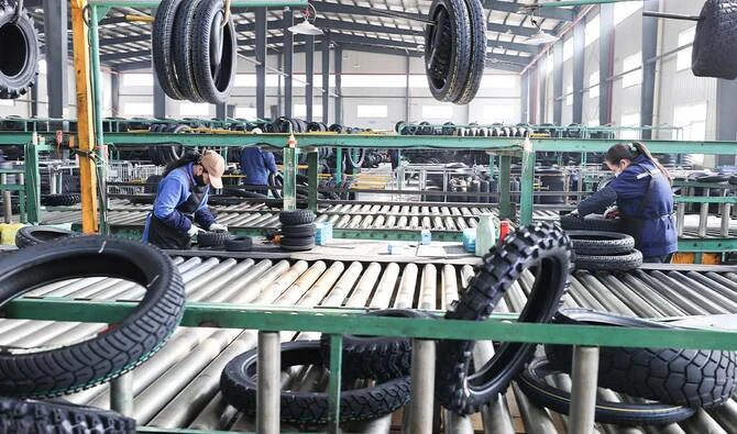 Workers process tyre orders destined for export at a vehicle company in Lianyungang, China’s eastern Jiangsu province on March 9, 2026. (AFP/ file)