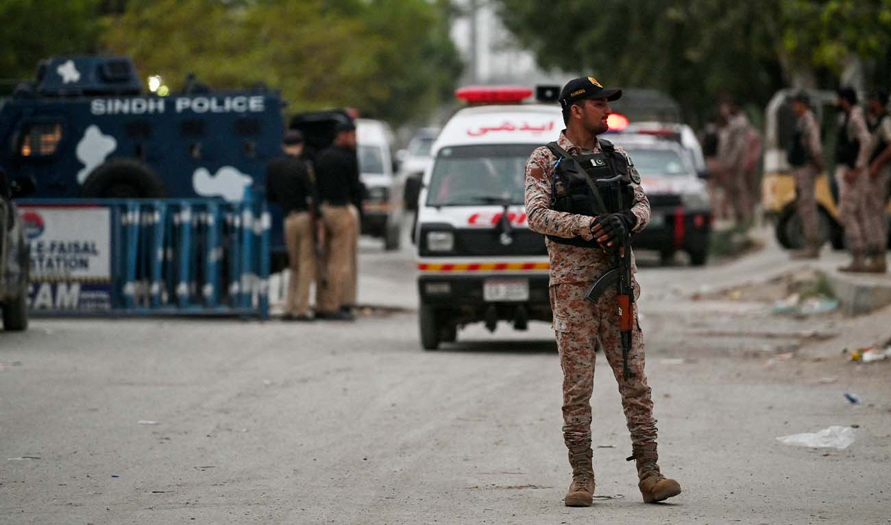A security personnel stands guard at the end of a clearance operation following an alleged explosion and a militant attack in Karachi on June 28, 2026. (AFP)