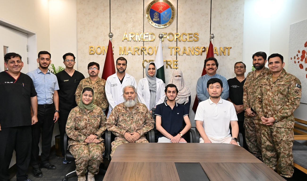 Medical professionals, military officials, and the patient pose for a group photograph at the Armed Forces Bone Marrow Transplant Centre (AFBMTC) in Rawalpindi, Pakistan. (X/Radio Pakistan)