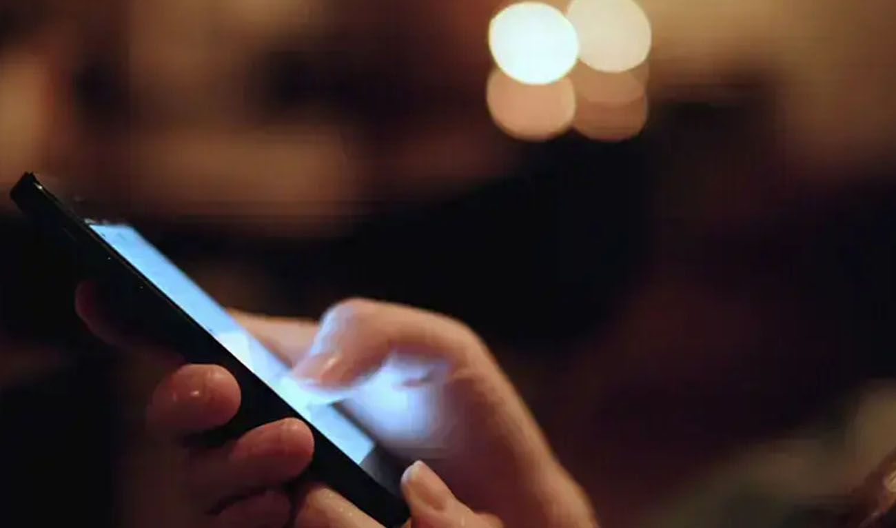 A file photo of a hand holding a mobile phone. (AFP/File)