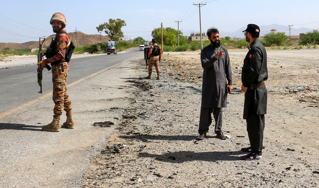 Security personnel stand guard at the site of a school bus bombing in Khuzdar district of Balochistan province on May 21, 2025. (AFP/ file)