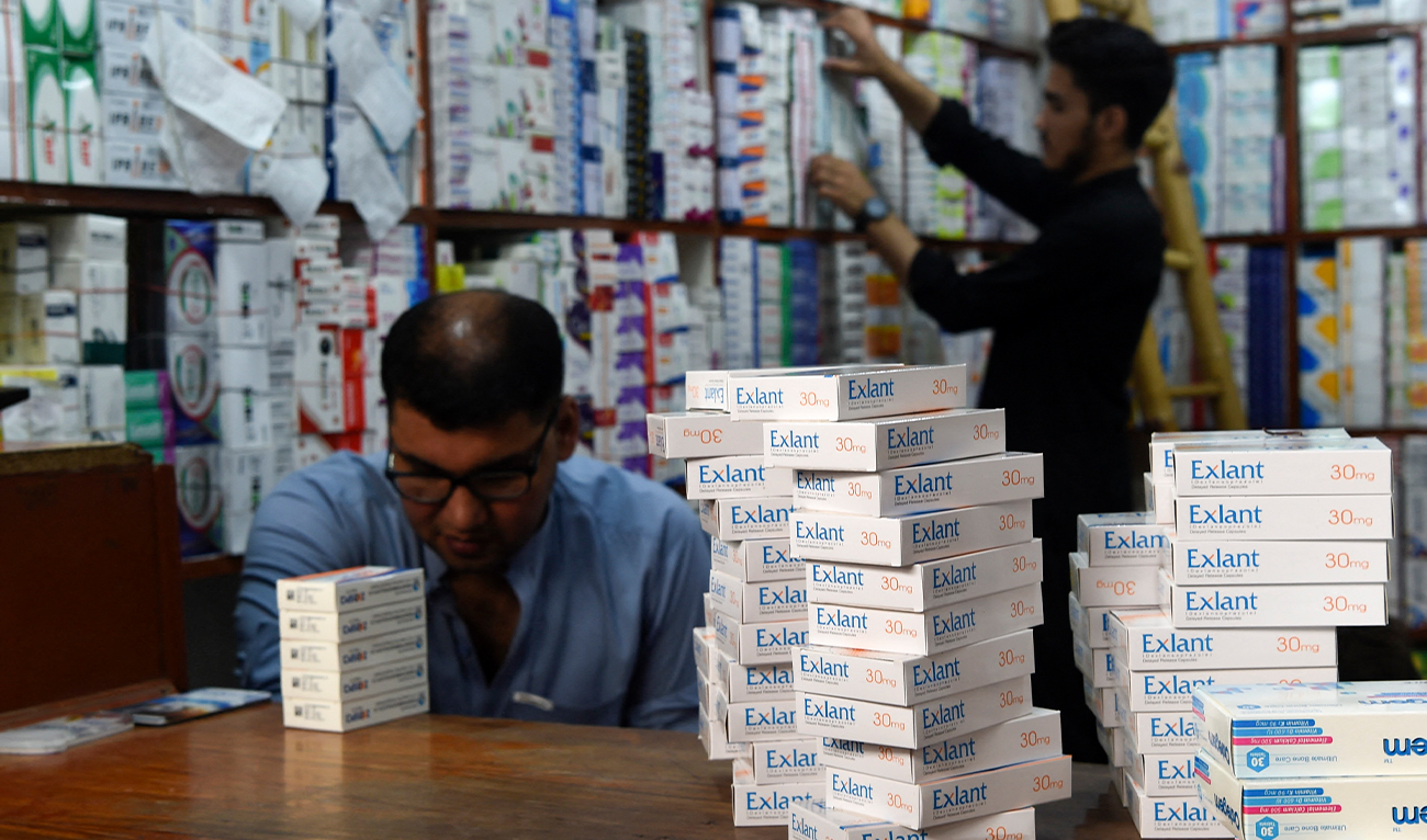 Pharmacists arrange medicines at a pharmacy shop in Peshawar on September 1, 2021. (AFP/ file)