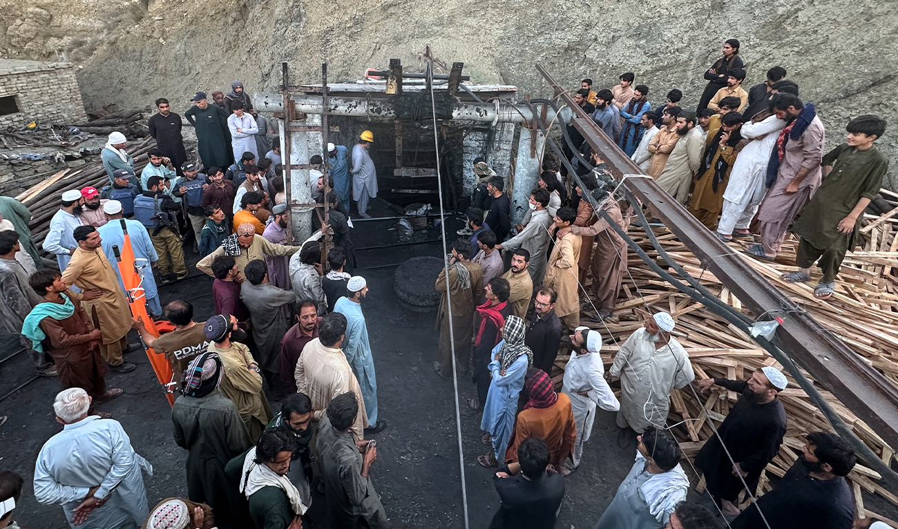 People gather as rescue workers attempt to reach miners trapped in a coal mine on the outskirts of Quetta, the capital of Balochistan province, in southwest Pakistan, on July 30, 2026. (AP)