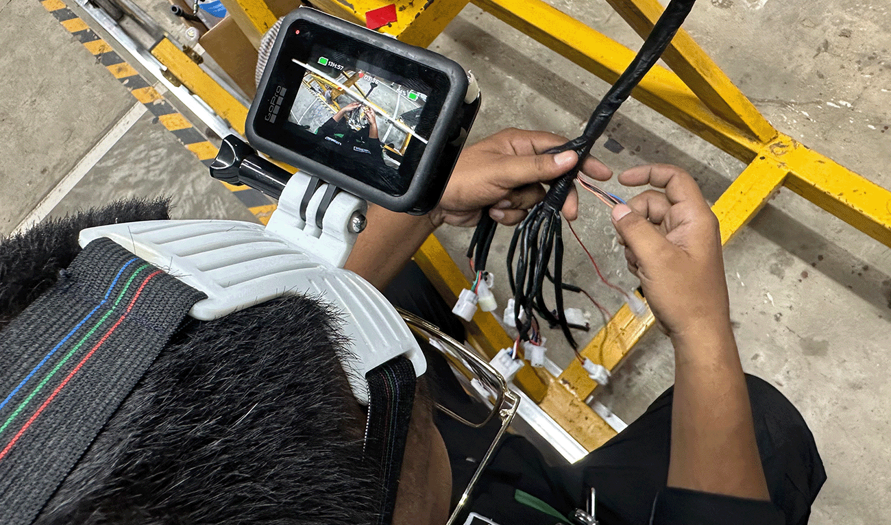 A worker wearing a headcam while working in a factory in Pakistan's Karachi on July 28, 2026, to record footage and movements that can be used to train AI robots. (AN Photo)