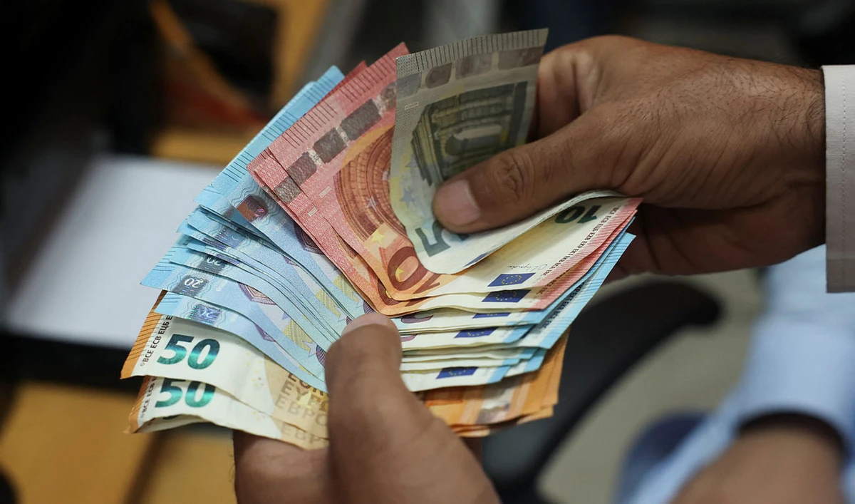 A trader counts currency of various countries at a currency exchange booth in Peshawar, Pakistan, July 29,2025. (REUTERS)