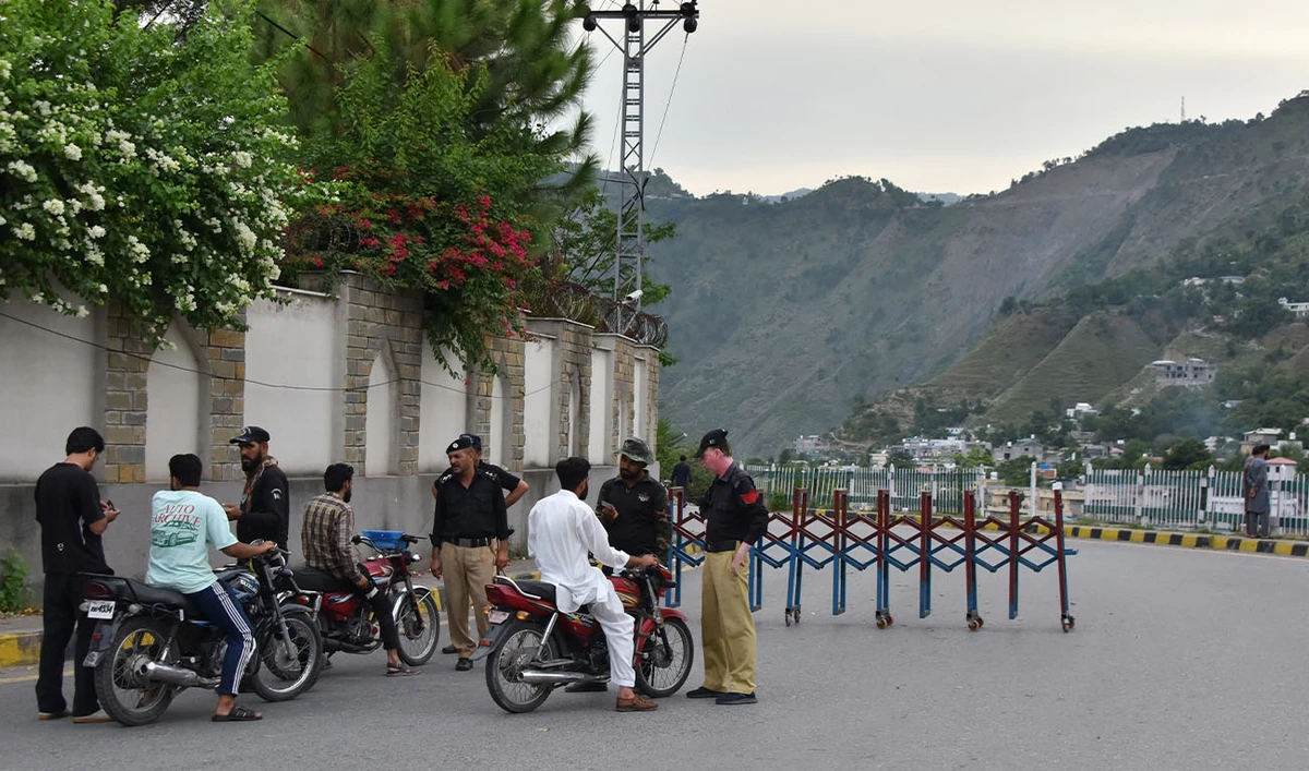 Police frisk people at a checkpoint in Muzaffarabad, the capital of Pakistan-administered Kashmir on July 15, 2026. (AFP/File)